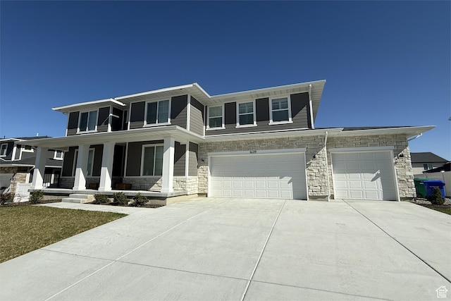 6129 W Coulee Ln, West Jordan, UT 84081 - view of front of property with an attached garage, a porch, stone siding, and concrete driveway