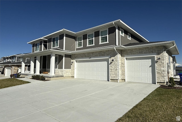 6129 W Coulee Ln, West Jordan, UT 84081 - view of front of property with concrete driveway, a porch, stone siding, and a garage