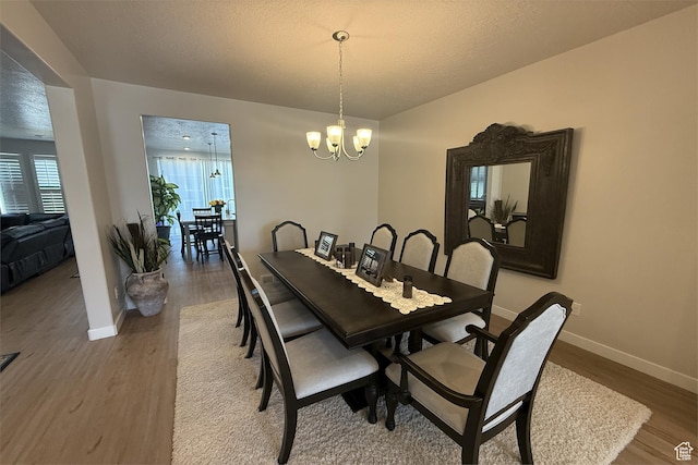 6129 W Coulee Ln, West Jordan, UT 84081 - dining area featuring baseboards, a notable chandelier, and wood finished floors