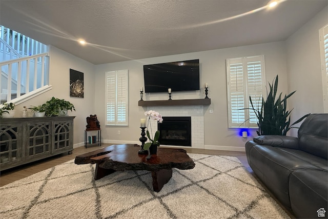 6129 W Coulee Ln, West Jordan, UT 84081 - living room with a fireplace, wood finished floors, baseboards, and stairs