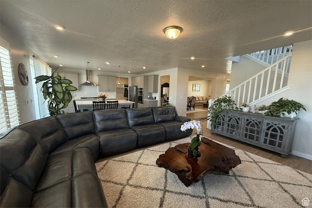 6129 W Coulee Ln, West Jordan, UT 84081 - living area with a textured ceiling, baseboards, recessed lighting, wood finished floors, and stairway