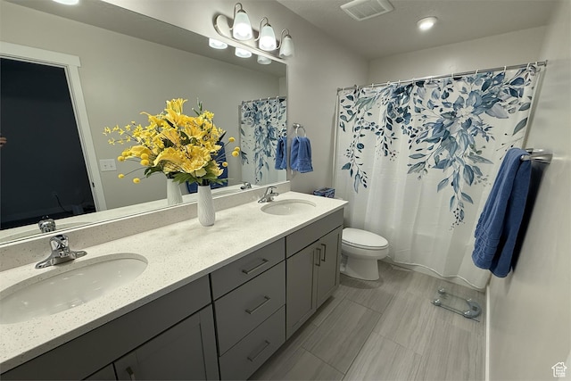 6129 W Coulee Ln, West Jordan, UT 84081 - full bathroom featuring visible vents, a sink, double vanity, and toilet