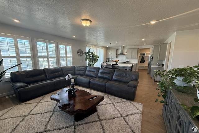 6129 W Coulee Ln, West Jordan, UT 84081 - living room with recessed lighting, wood finished floors, and a textured ceiling