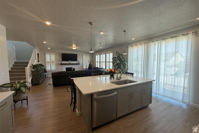 6129 W Coulee Ln, West Jordan, UT 84081 - kitchen with wood finished floors, a sink, a textured ceiling, dishwasher, and light countertops