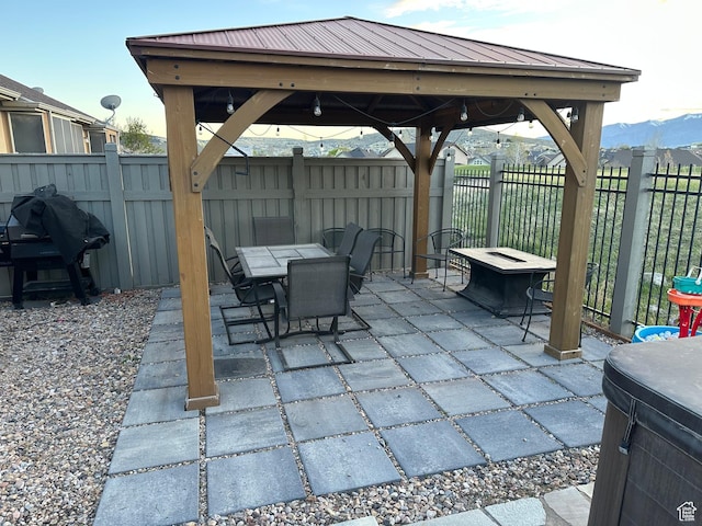 8675 N Franklin Dr E, Eagle Mountain, UT 84005 - view of patio featuring a fenced backyard, a gazebo, outdoor dining space, and grilling area