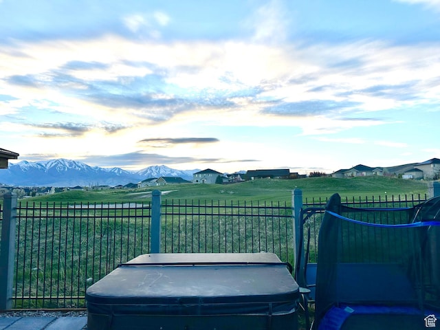8675 N Franklin Dr E, Eagle Mountain, UT 84005 - view of yard with a rural view, a hot tub, fence, and a mountain view