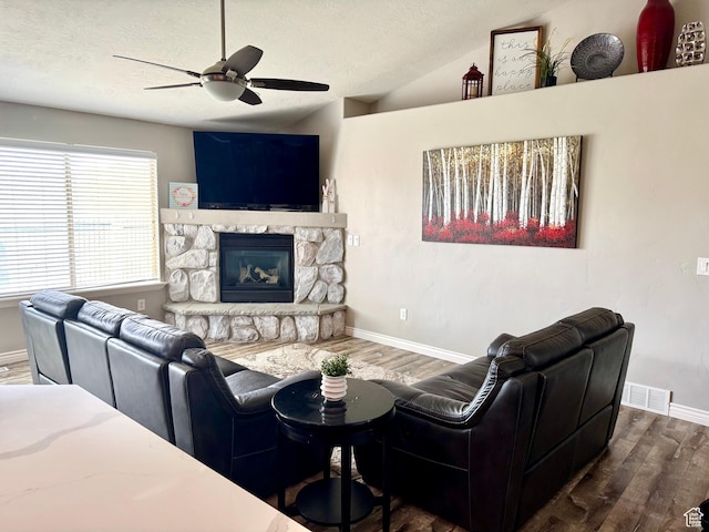 8675 N Franklin Dr E, Eagle Mountain, UT 84005 - living area featuring visible vents, baseboards, a ceiling fan, wood finished floors, and a stone fireplace