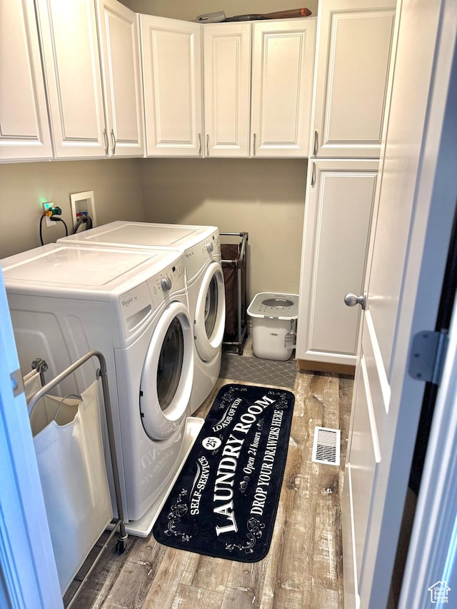 8675 N Franklin Dr E, Eagle Mountain, UT 84005 - clothes washing area with cabinet space, independent washer and dryer, wood finished floors, and visible vents