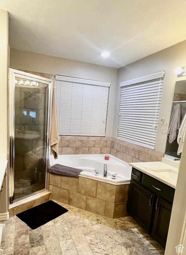 8675 N Franklin Dr E, Eagle Mountain, UT 84005 - full bathroom with a garden tub, vanity, and a stall shower