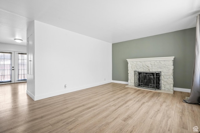 4217 S Hopi Dr, West Valley City, UT 84119 - unfurnished living room featuring wood finished floors, french doors, a fireplace, and baseboards