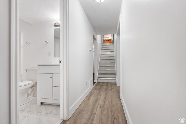 4217 S Hopi Dr, West Valley City, UT 84119 - corridor with stairway, baseboards, and light wood finished floors