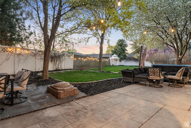 1380 S 980 E, Spanish Fork, UT 84660 - patio terrace at dusk featuring a fenced backyard, a gazebo, outdoor lounge area, a lawn, and outdoor dining area