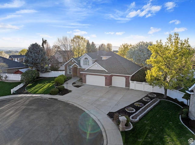 1380 S 980 E, Spanish Fork, UT 84660 - view of front of home with a front lawn, an attached garage, driveway, fence private yard, and brick siding
