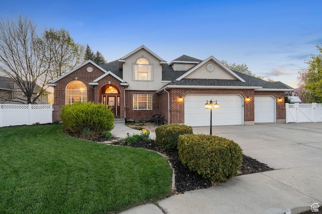 1380 S 980 E, Spanish Fork, UT 84660 - traditional-style house featuring a gate, driveway, fence, a front yard, and a garage