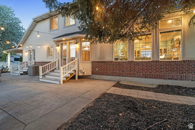 1380 S 980 E, Spanish Fork, UT 84660 - view of front facade featuring brick siding, a patio area, central AC, and stucco siding