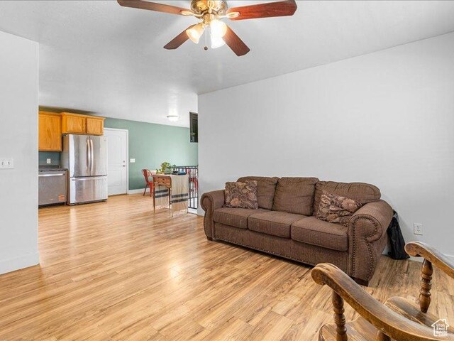 606 N 200 W, Ephraim, UT 84627 - living room with light wood finished floors, a ceiling fan, and baseboards
