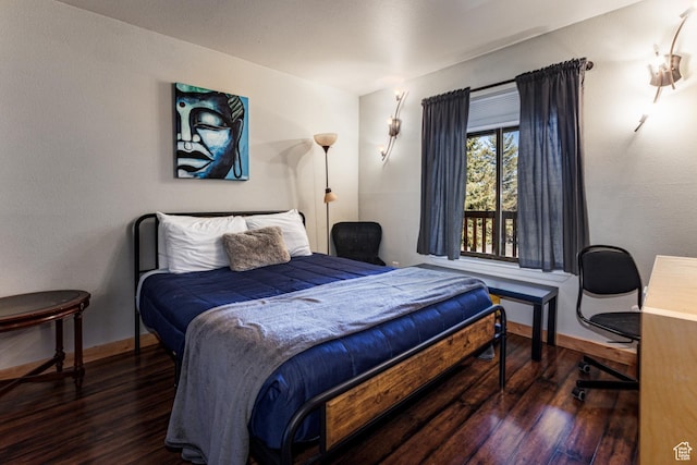 bedroom featuring baseboards and wood finished floors