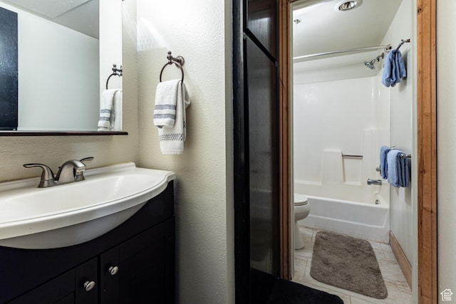 bathroom with vanity, washtub / shower combination, and toilet