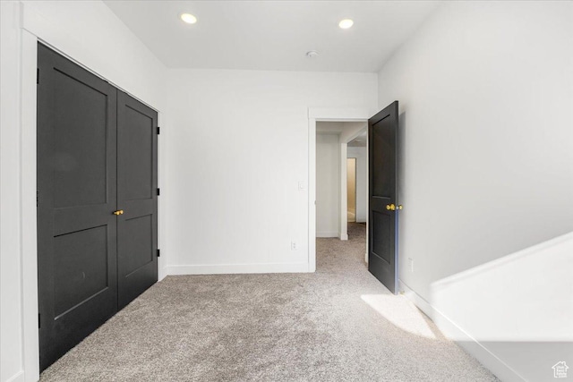 unfurnished bedroom with baseboards, recessed lighting, and carpet