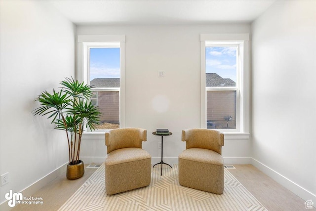 sitting room featuring visible vents and baseboards