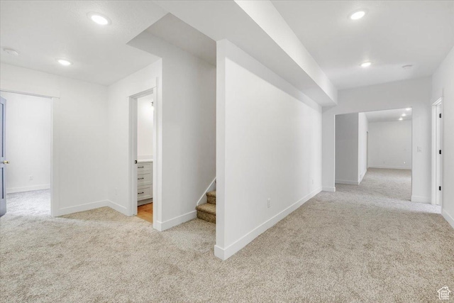 hallway with recessed lighting, carpet floors, baseboards, and stairway