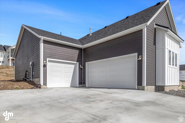view of property exterior featuring driveway and a garage