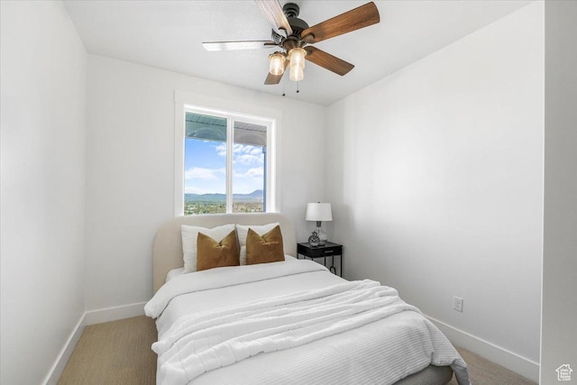 bedroom featuring carpet flooring, baseboards, and a ceiling fan