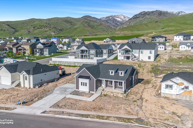 birds eye view of property with a mountain view and a residential view