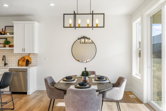 dining area featuring plenty of natural light and light wood-type flooring