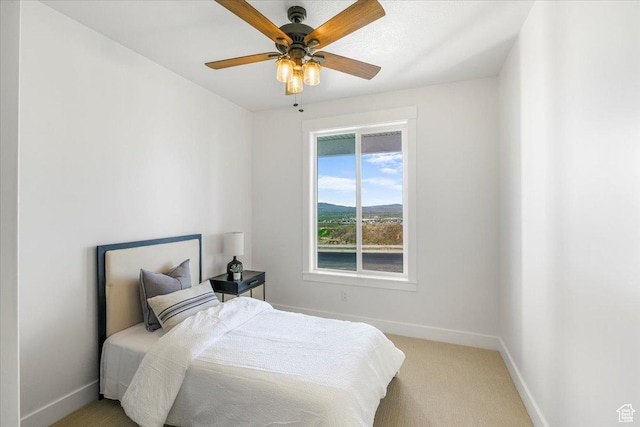 bedroom with carpet, a ceiling fan, and baseboards