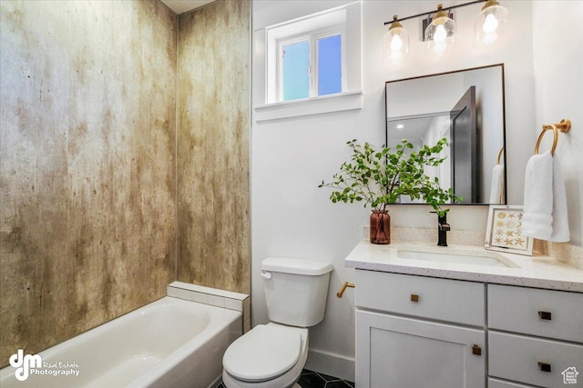 full bathroom with toilet, vanity, and baseboards