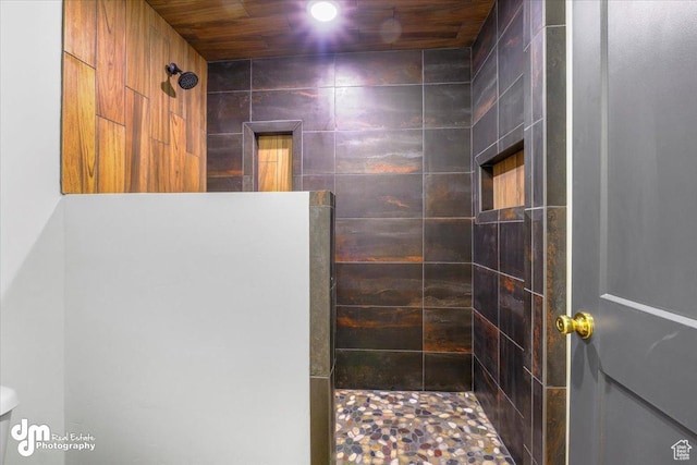 bathroom featuring walk in shower and toilet