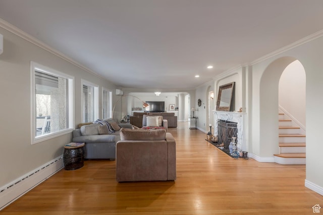 381 E 11th Ave, Salt Lake City, UT 84103 - living area with baseboard heating, arched walkways, and crown molding