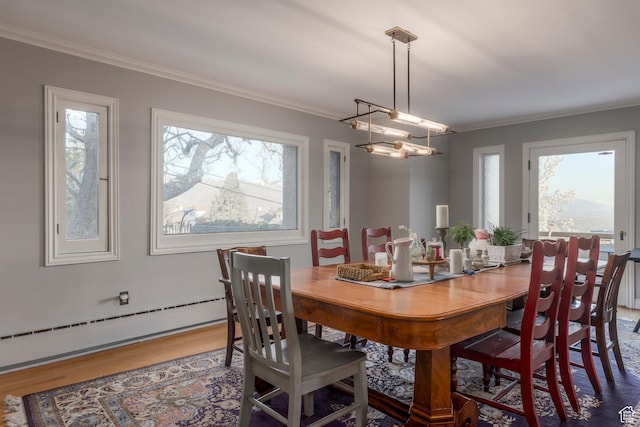 381 E 11th Ave, Salt Lake City, UT 84103 - dining space with baseboard heating, ornamental molding, wood finished floors, and plenty of natural light