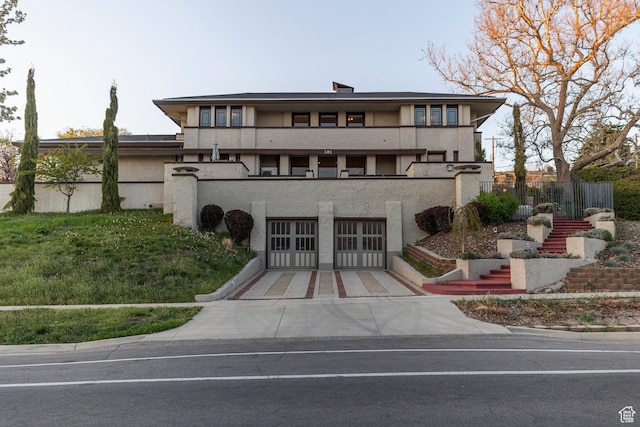 381 E 11th Ave, Salt Lake City, UT 84103 - view of front of property featuring stucco siding, concrete driveway, stairs, and a garage