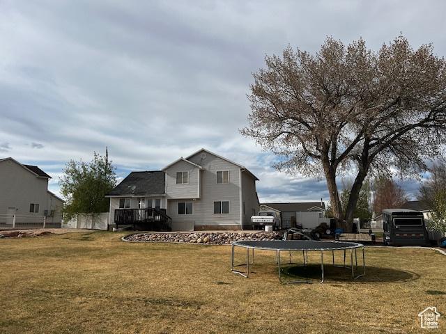 1115 Park Ridge Dr, Roosevelt, UT 84066 - back of house featuring a trampoline and a lawn