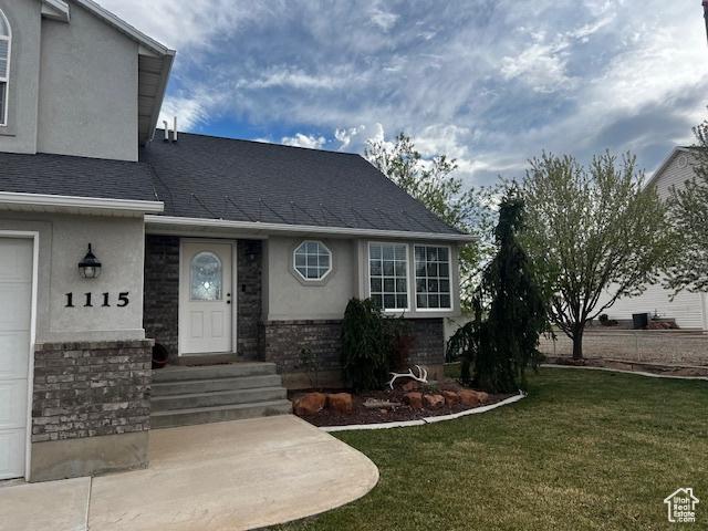 1115 Park Ridge Dr, Roosevelt, UT 84066 - view of front of property with a garage, a front lawn, roof with shingles, and stucco siding