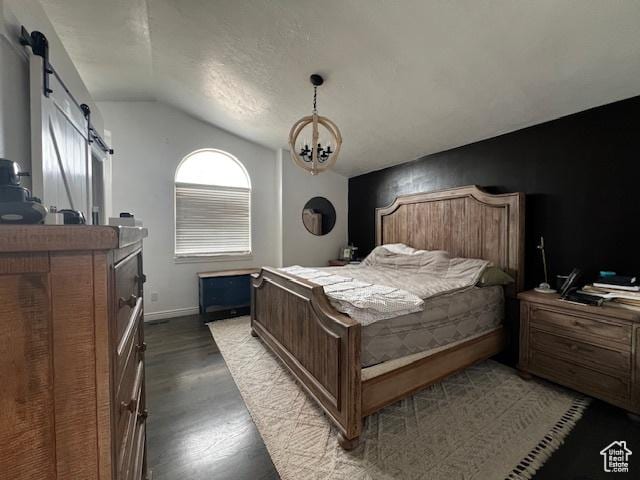 1115 Park Ridge Dr, Roosevelt, UT 84066 - bedroom with a barn door, lofted ceiling, a chandelier, and dark wood-type flooring