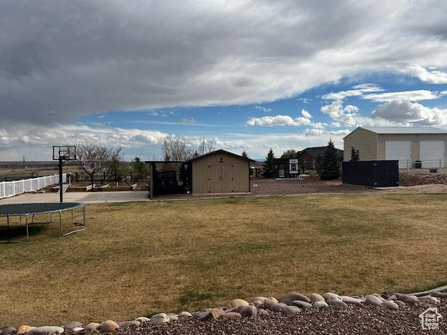1115 Park Ridge Dr, Roosevelt, UT 84066 - view of yard with an outbuilding and a trampoline