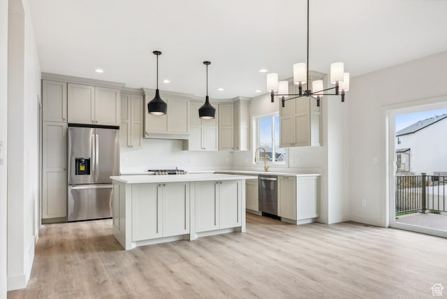 178 N Husker Ln Unit 2, Saratoga Springs, UT 84043 - kitchen with light wood-style floors, stainless steel appliances, light countertops, baseboards, and a notable chandelier