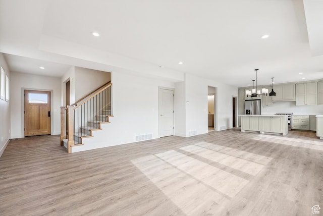 178 N Husker Ln Unit 2, Saratoga Springs, UT 84043 - unfurnished living room featuring stairway, light wood-style floors, baseboards, visible vents, and recessed lighting