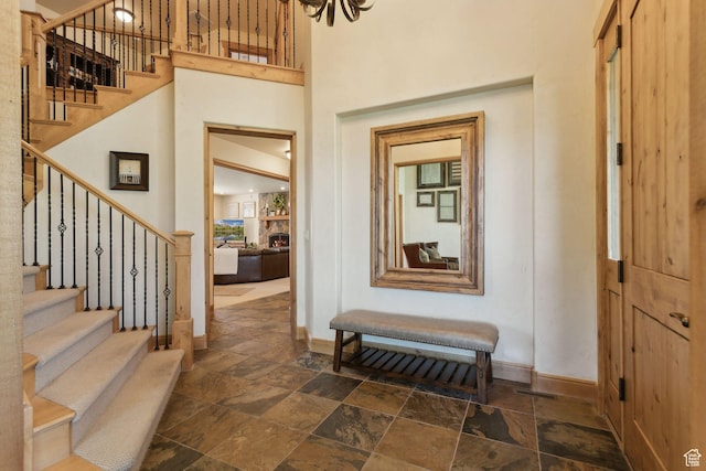 2605 E Woodland Way, Woodland, UT 84036 - foyer entrance with baseboards, stone tile flooring, stairs, and a towering ceiling
