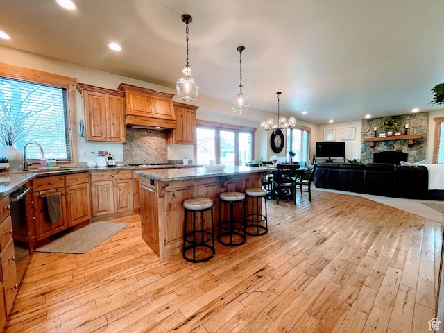 2605 E Woodland Way, Woodland, UT 84036 - kitchen with recessed lighting, a kitchen breakfast bar, stone countertops, a center island, and light wood-style flooring