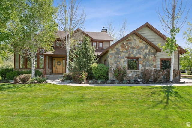 2605 E Woodland Way, Woodland, UT 84036 - view of front facade featuring stone siding, a front lawn, and a chimney