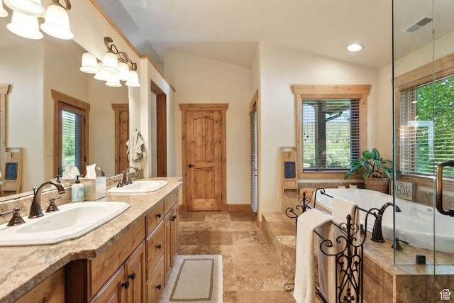 2605 E Woodland Way, Woodland, UT 84036 - bathroom featuring double vanity, a garden tub, lofted ceiling, stone tile flooring, and recessed lighting