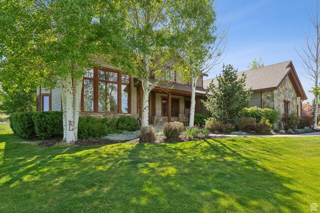 2605 E Woodland Way, Woodland, UT 84036 - view of property hidden behind natural elements with stone siding and a front lawn