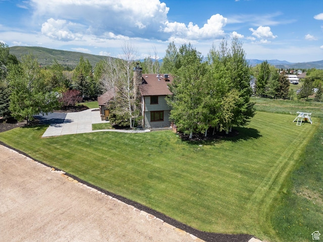 2605 E Woodland Way, Woodland, UT 84036 - view of front facade featuring a chimney, a mountain view, and a front lawn