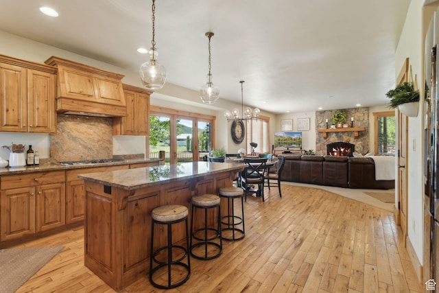 2605 E Woodland Way, Woodland, UT 84036 - kitchen with a kitchen island, light wood-type flooring, stainless steel gas cooktop, backsplash, and recessed lighting