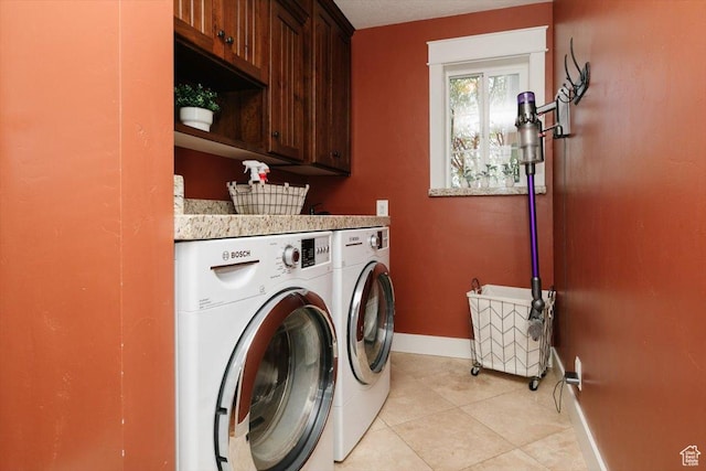 770 Orchard Dr, River Heights, UT 84321 - laundry area with light tile patterned floors, washing machine and clothes dryer, cabinet space, and baseboards
