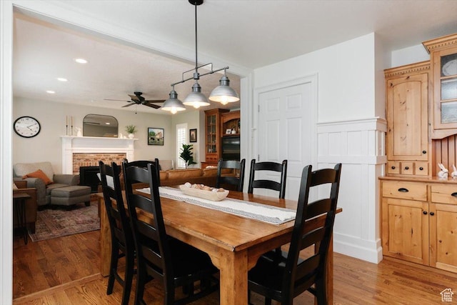 770 Orchard Dr, River Heights, UT 84321 - dining room with recessed lighting, a ceiling fan, light wood-style floors, and a fireplace